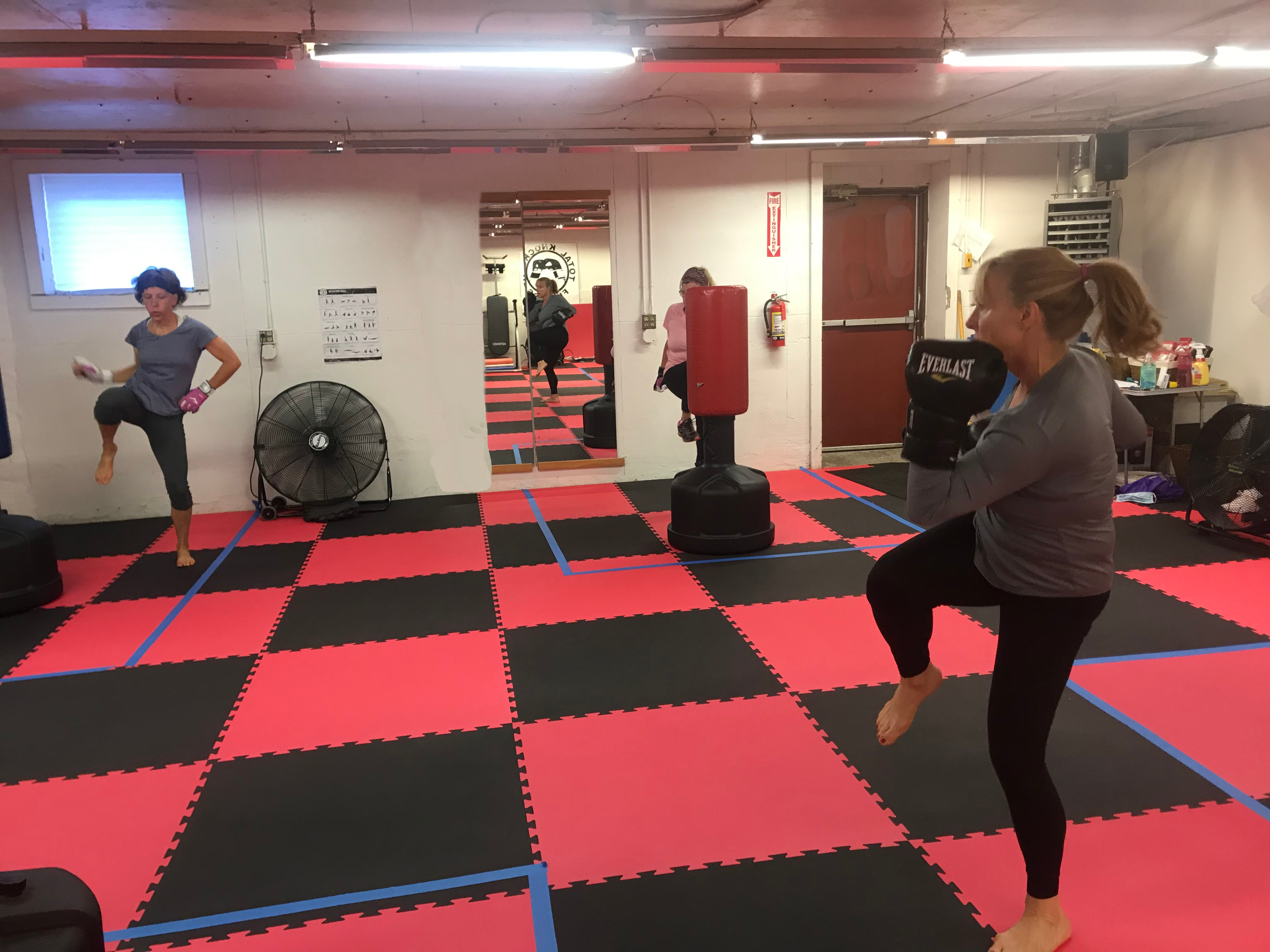 two women exercising with gloves on as part of kickboxing